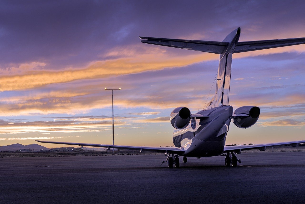 Private jet on the tarmac at sunset